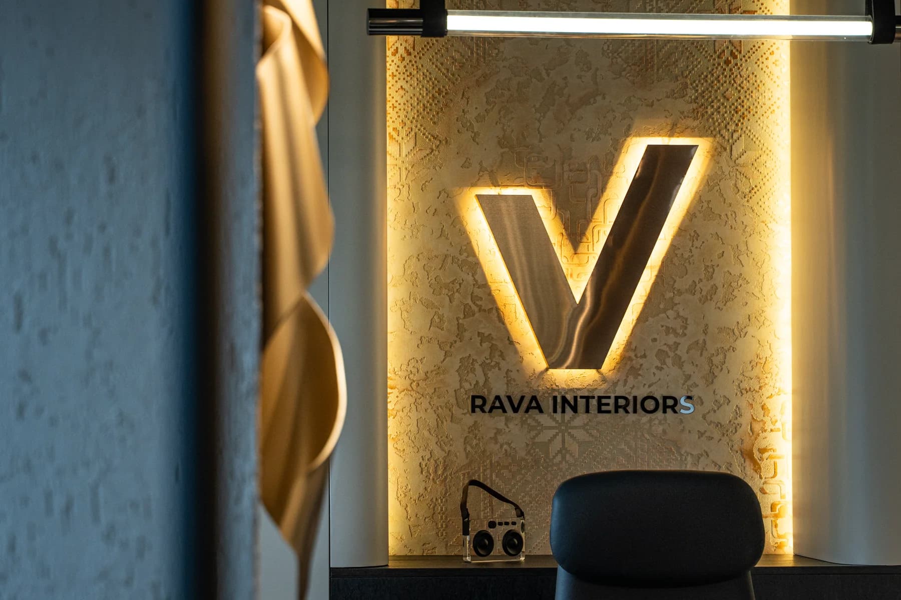 RAVA Interiors illuminated studio brand wall